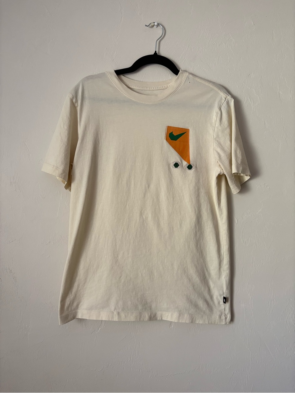 Nike Cream Short-Sleeve Tee with Orange Pocket and Green Swoosh